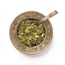 Green yerba mate packed into a gourd with a metal straw standing in it